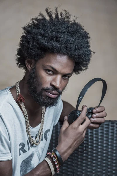 Retrato de um afro-americano de cabelos encaracolados com fones de ouvido — Fotografia de Stock