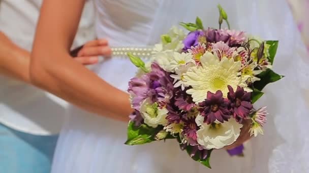 The grooms hands gently hug the brides waist, wedding bouquet — Stock Video