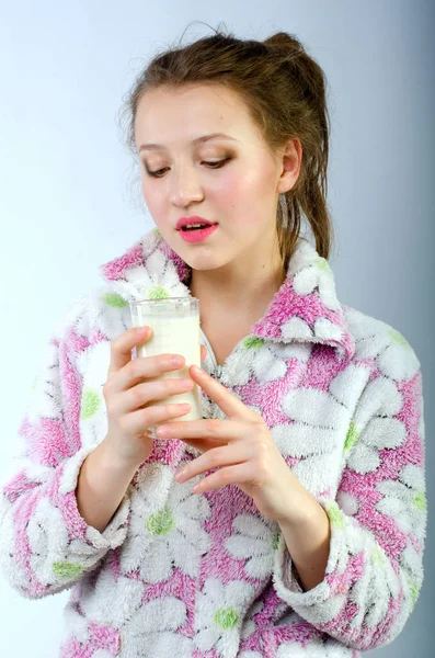 Beautiful girl in pajamas with milk — Stock Photo, Image