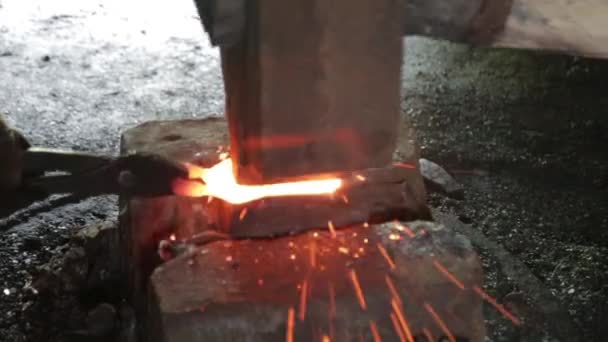 Blacksmith forges fierce metal hammer. Hot iron. Sparks. — Stock Video