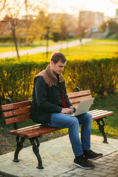 El joven gerente trabajando en un portátil en el parque. Pausa para el almuerzo . —  Fotos de Stock