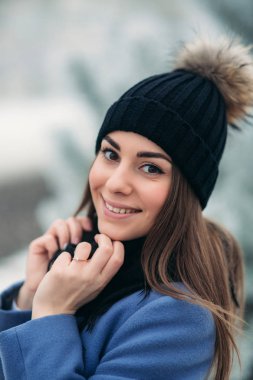 Kışın karlı manzarada genç bir kadının güzel kış portresi.