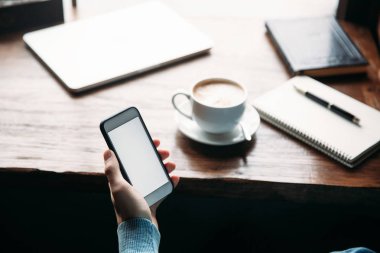 Kahve yudumlarken içinde bir restoran telefonu kullanan adam
