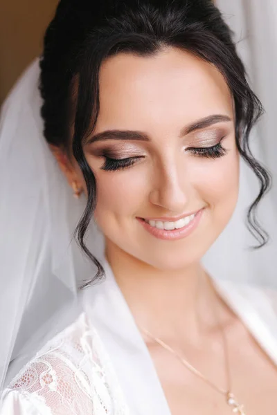 Primer plano retrato de la novia hermosa en el hotel por la mañana. Encantadora mujer con gran peinado y maquillaje — Foto de Stock