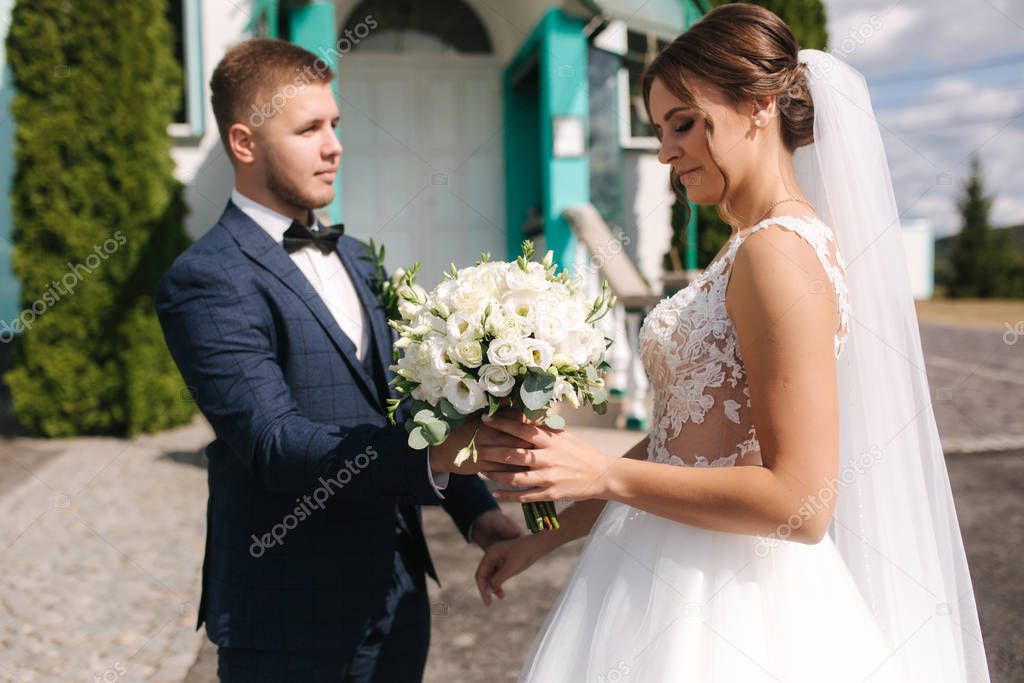 Firtst look of groom and bride by the church