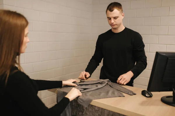 Woman shopping in clothe store. Male customer