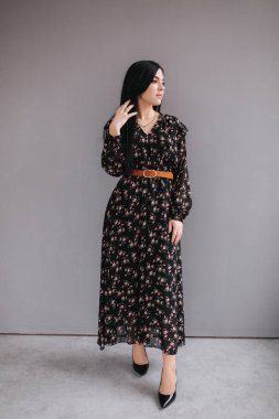 Genç esmer model. Stüdyoda bahar kıyafetlerini gösteriyor.