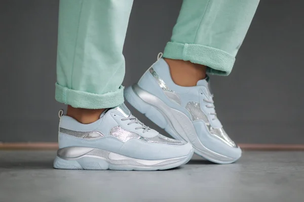 Female demostrating snaekers on her feet. Close up of sneakers — Stock Photo, Image