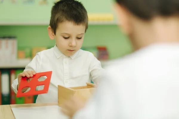 Little boy play with different figures in kindergarden. Boys play together in nursery — Stock Photo, Image