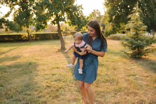 Mama se joacă cu fetiţa în parc. La mulţi ani. Draguta copil cu mama frumoasa — Fotografie, imagine de stoc