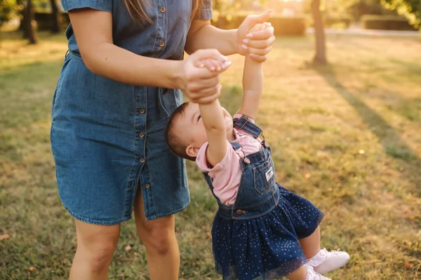 Mom play with little daughter in the park. Happy moment. Cute baby with beautiful mom — Stock Photo, Image