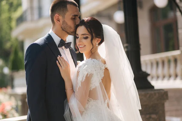 Wedding couple of groom and bride stand on balcony. Beautiful couple — Stock Photo, Image