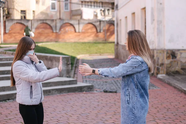 Mädchen in Masken. Coronavirus Thema. Frauen in der Stadt gehen während der Quarantäne spazieren. Keine Umarmungen — Stockfoto