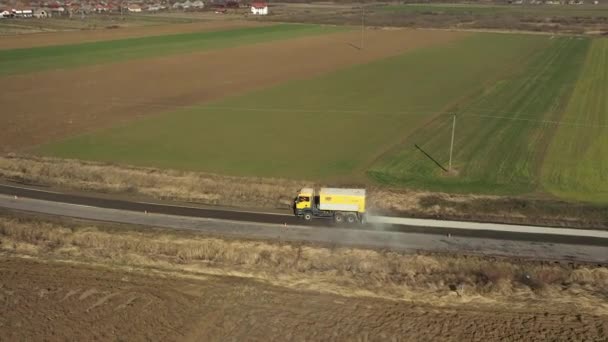 Aerial view of truck spills out sand on the road — Stock Video