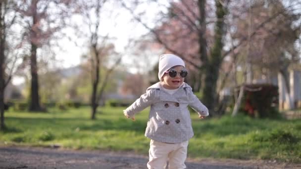 Happy little girl dance in the park. Stylish kid — Stock Video
