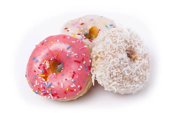 Three donuts isolated on White Background. Pink, Frosted and Coconut with sprinkles. — Stock Photo, Image