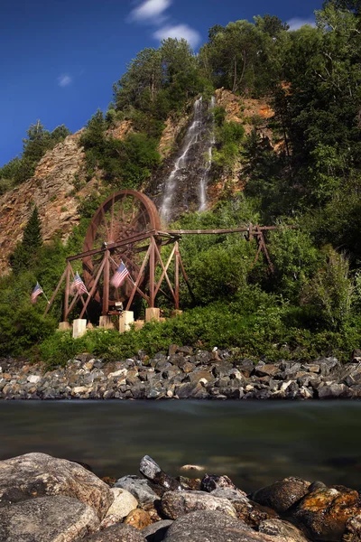 Waterfall and water wheel in Idaho Springs Colorado next to the I-70 Freeway. — Stock Photo, Image