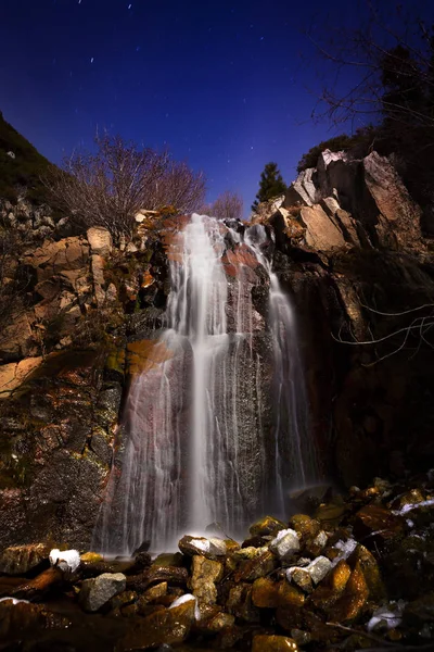 Waterfall in moonlight with stars — Stock Photo, Image