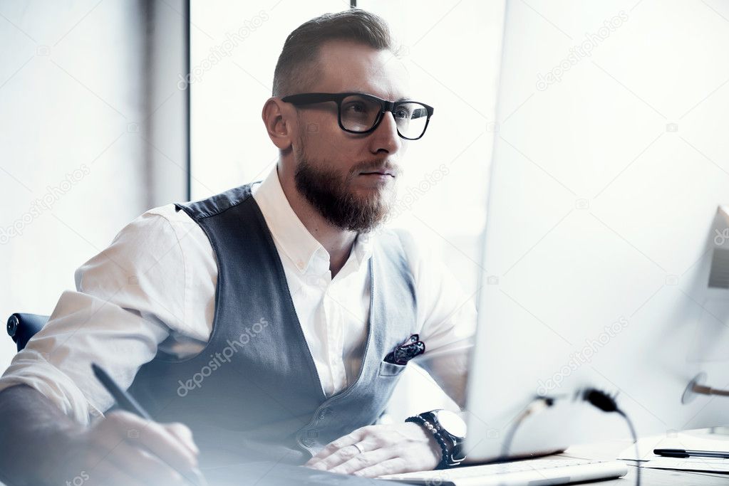 Portrait Bearded Stylish Young Man Wearing Glasses White Shirt Waistcoat Work Modern Loft Online Startup Project.Creative People Working Digital Tablet Drawing Desktop Computer Wood Table.Blurred.