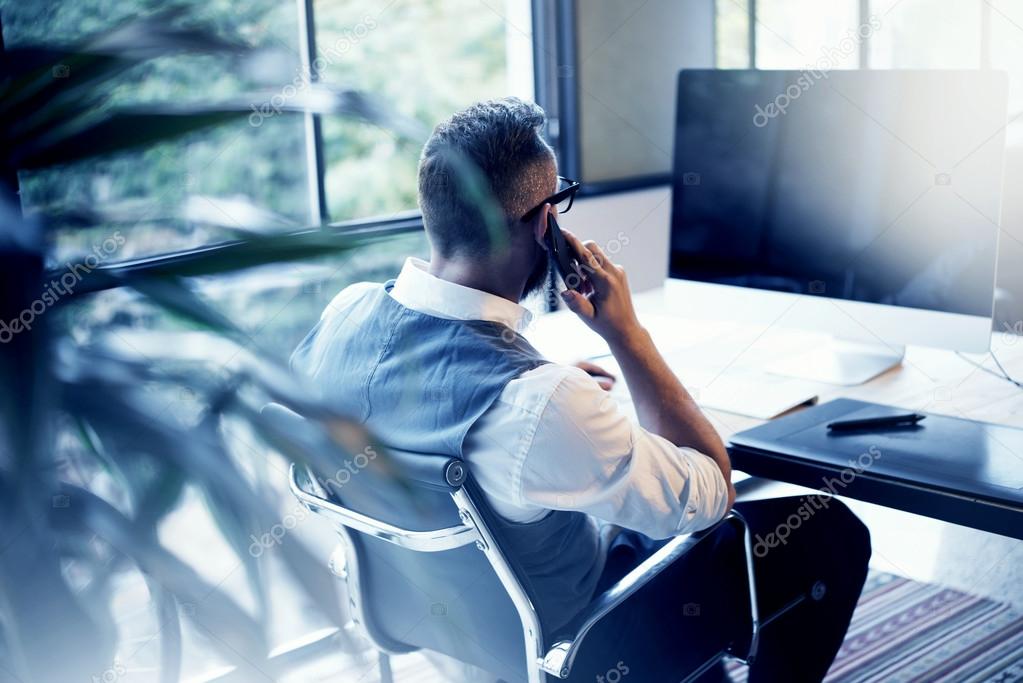 Bearded Businessman Wearing White Shirt Waistcoat Working Modern Loft Startup Computer.Creative Young Man Using Mobile Phone Call Partner Meeting.Person Work Digital Tablet Desktop Table Workplace.