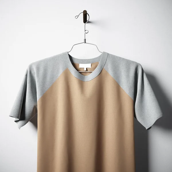 Closeup of blank multicolor cotton tshirt hanging in center  empty concrete wall. Clear label mockup with highly detailed textured materials. Square. Front side view. 3D rendering. — Stock Photo, Image