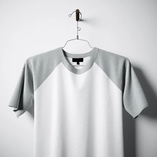 Closeup of blank white and gray cotton tshirt hanging in center empty concrete wall. Clear label mockup with highly detailed textured materials. Square. Front side view. 3D rendering. — Stock Photo, Image