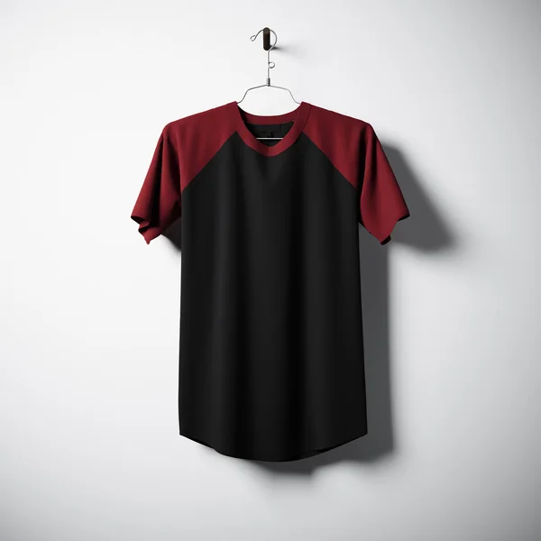 Blank black and red cotton tshirt hanging in center of empty concrete wall. Clear label mockup with highly detailed textured materials. Square. Front side view. 3D rendering. — Stock Photo, Image