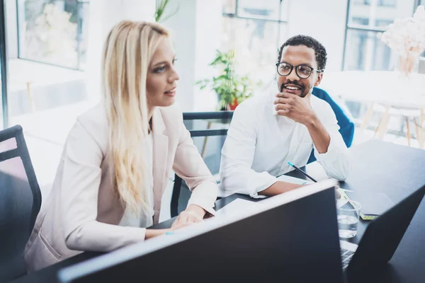 Two young business people working together in a modern office.Horizontal,blurred . — Stock Photo, Image