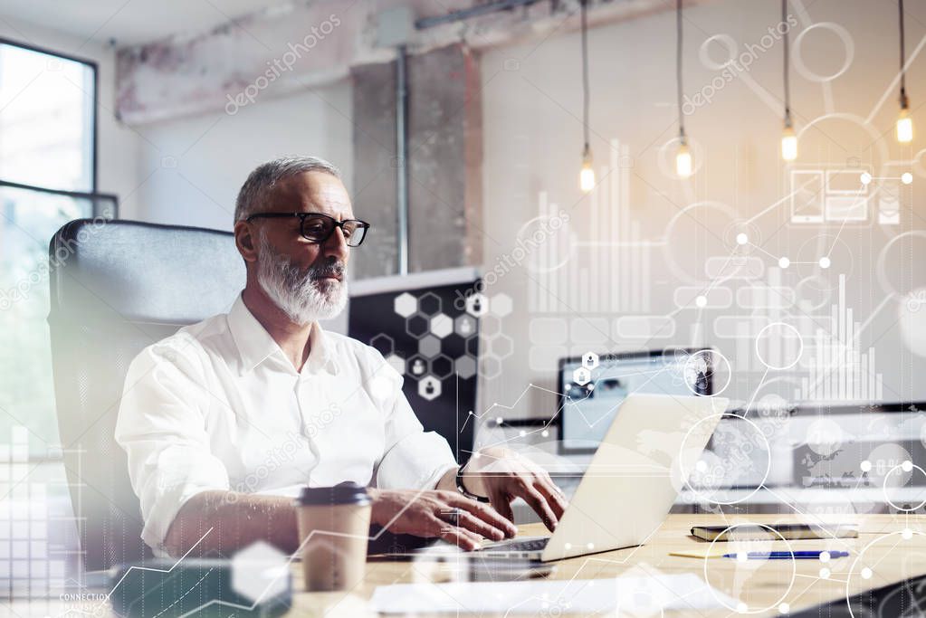 Concept of digital screen,virtual icon,diagram, graph and interfaces.Middle age financial analyst wearing a classic glasses, working at the wood table with exchange markets.Horizontal.