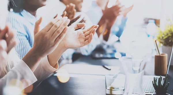 Close up of young business partners applauding to reporter after listening report at seminar. Professional education, work meeting, presentation or coaching concept.Horizontal,blurred background. — Stock Photo, Image