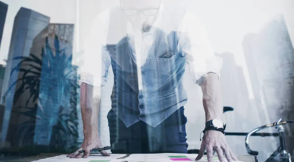 Bearded young businessman wearing white shirt,waistcoat and looking new startup.Concept of successful business.Double exposure,skyscraper office building on blurred background. — Stock Photo, Image