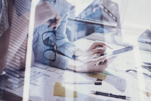 Closeup view of female hands touching screen modern smartphone.Concept business people using mobile gadgets.Double exposure,skyscraper office building blurred background.Horizontal, film effect. — Stock Photo, Image