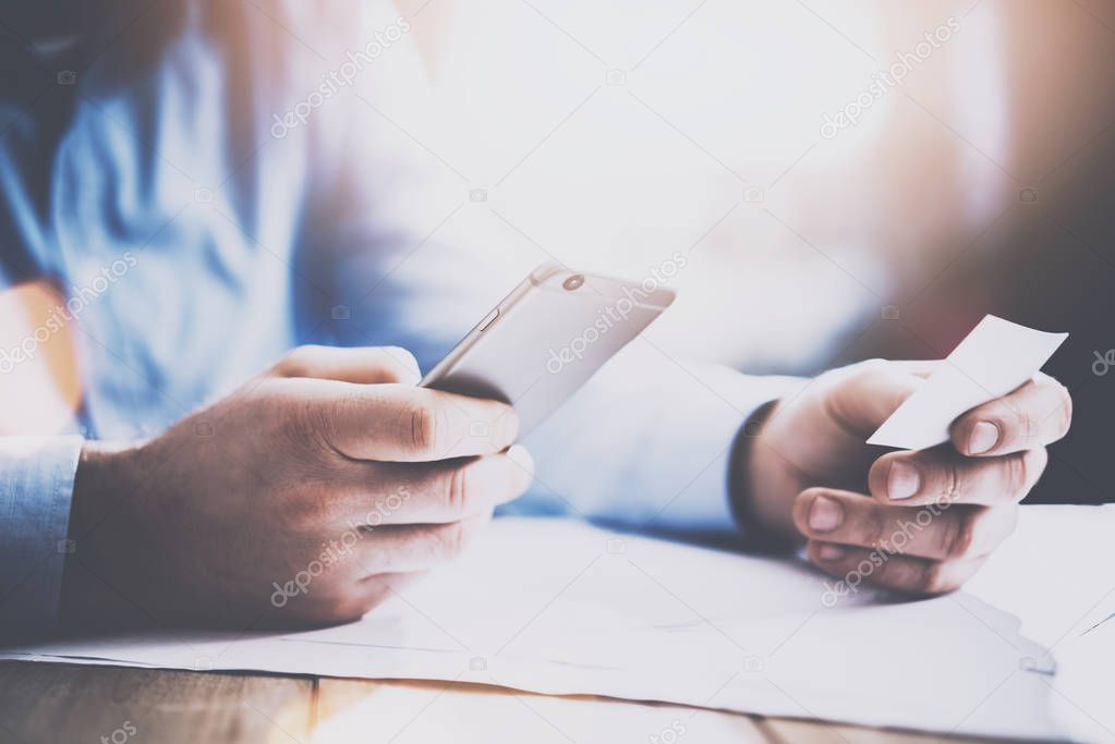 businessman holding card and smartphone 