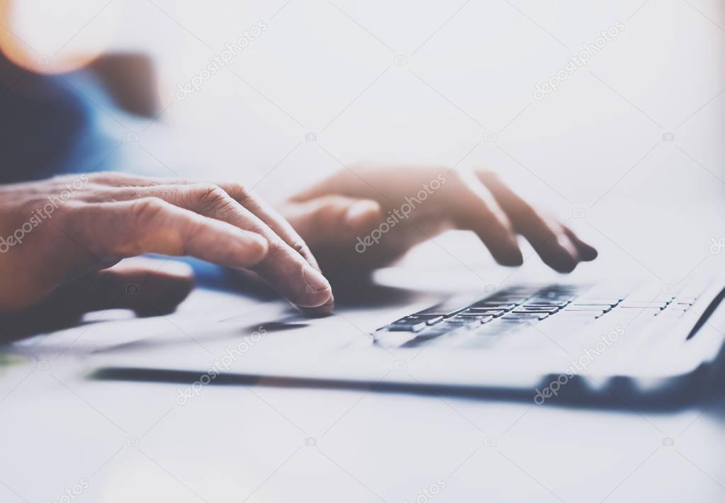 male hands typing on laptop keyboard.