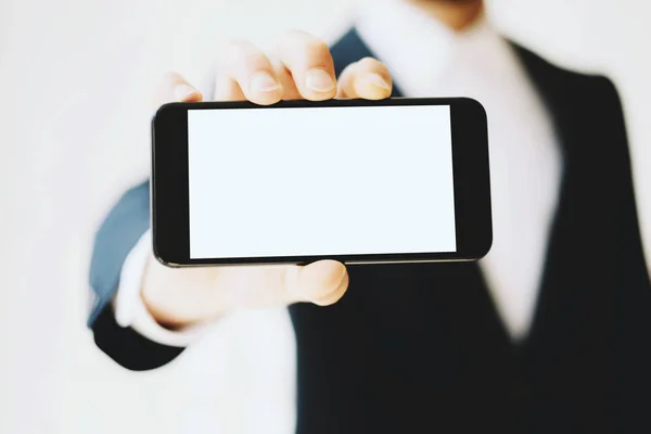Businessman showing smartphone — Stock Photo, Image
