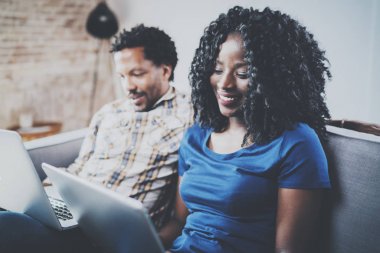 Afrikalı-Amerikalı çift modern dizüstü bilgisayarlar kullanarak