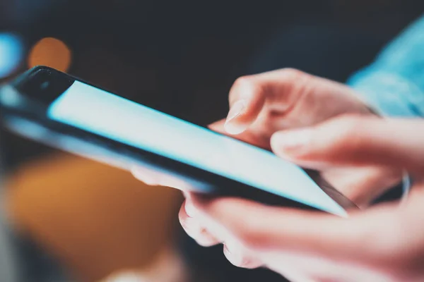 Closeup view of woman holding modern smartphone in hands.Girl pointing fingers on empty white touch mobile screen. Horizontal, blurred background, bokeh effects.Macro. — Stock Photo, Image