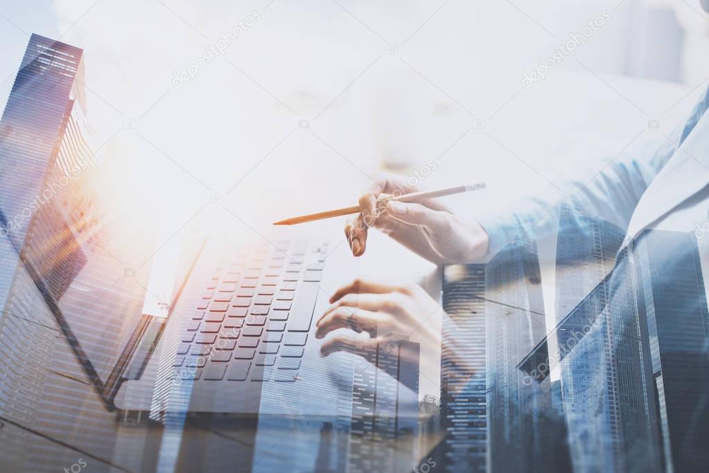 businesswoman working on laptop and skyscrapers