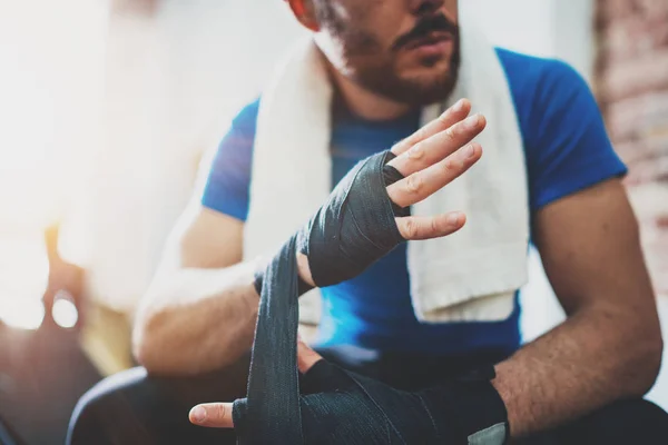Athlete tying boxing bandages
