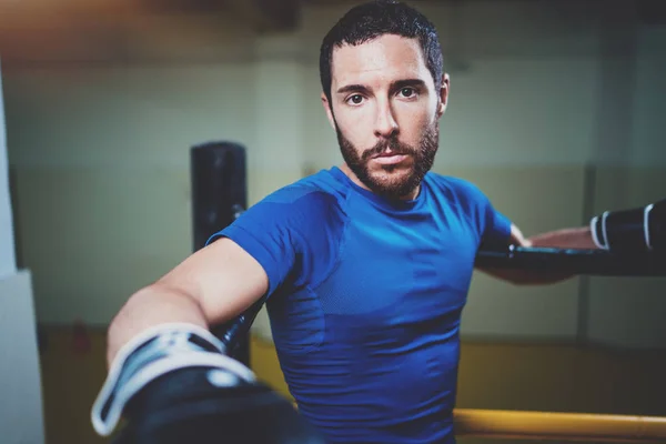 Young boxing man on ring