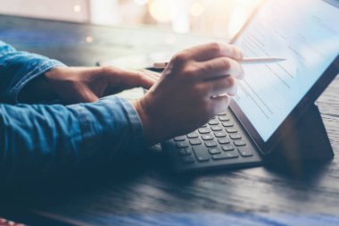 Elektronik kalem ve tabla kullanan adam