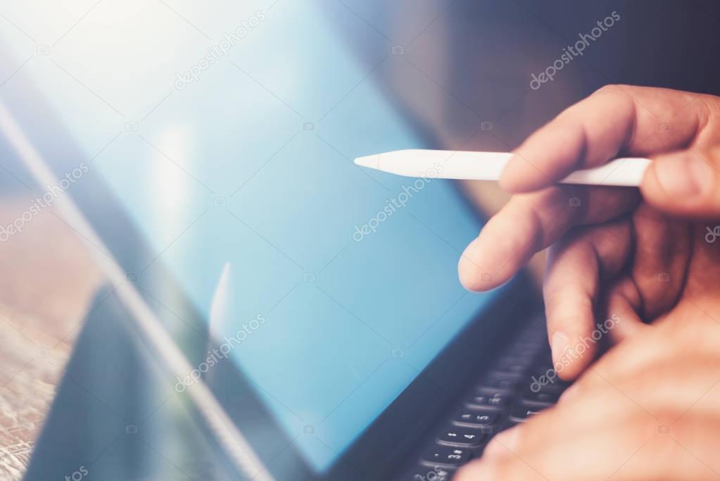man using electronic pen and tablet