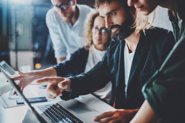 İşlem ofiste çalışıyor. Grup genç iş modern coworking studio birlikte çalışır. Gençler ortakları ile sohbet ediyoruz. Horizontal.Blurred arka plan. Kırpılmış