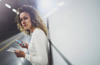 Güzel kız konuşma tatil seyahat için cep telefonu app kullanarak mutlu. Demiryolu tren istasyonu beklerken cep telefonuyla transit platformda güzel kadın.