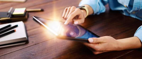 Woman pointing on digital tablet screen, chatting in social netw
