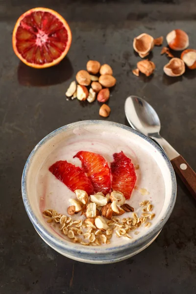 Yogurt with red orange, nuts and oats — Stock Photo, Image