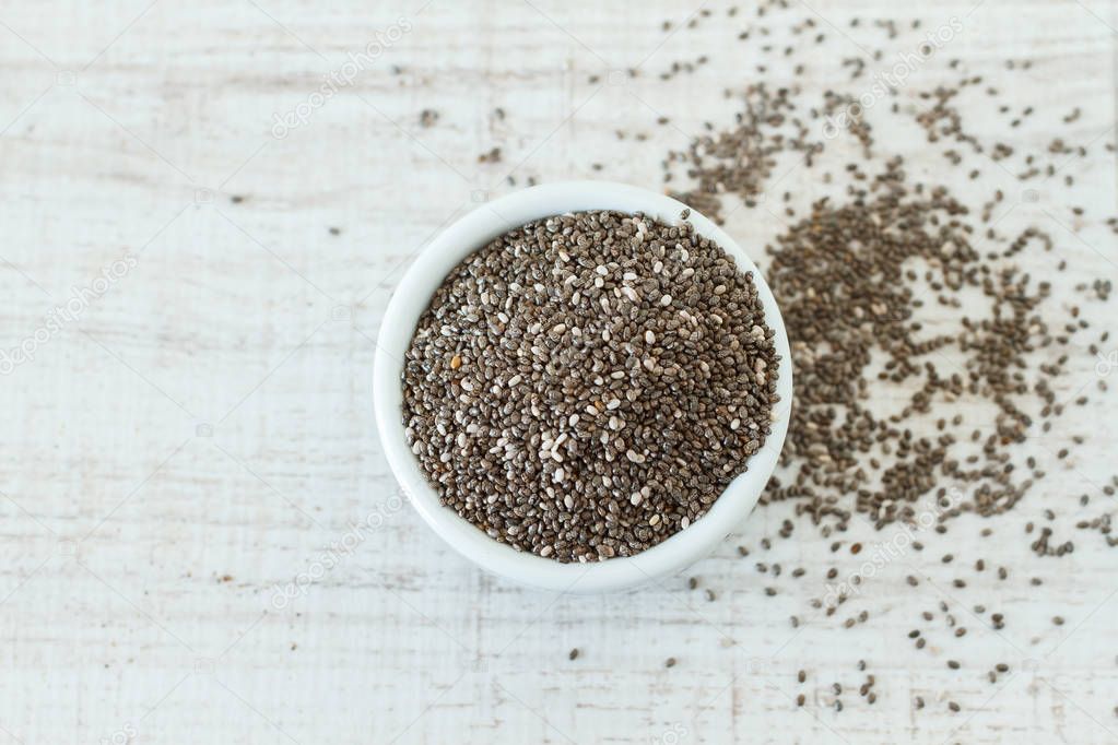 Superfood: chia seeds in an white bowl, top view