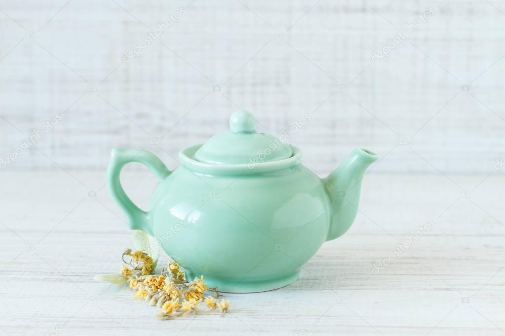 Vintage small green teapot with dried linden flowers