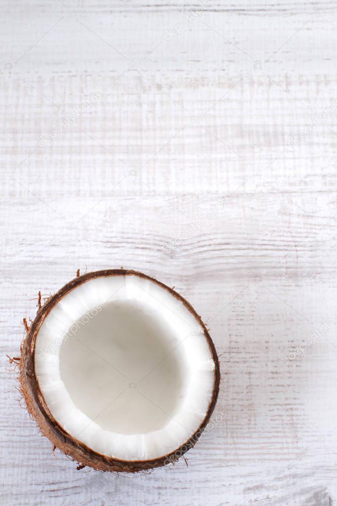 Half of coconut on a wooden surface