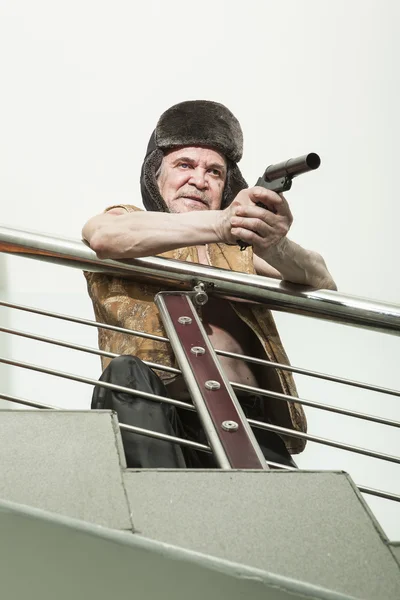 Armed robber with a gun on the emergency stairs — Stock Photo, Image